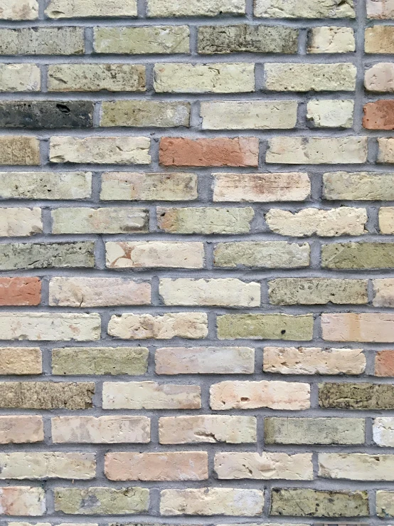 a brick wall with different colored bricks on top