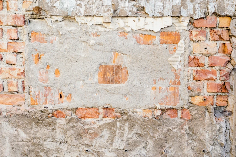 the faded paint is chipped in to a very rough brick wall