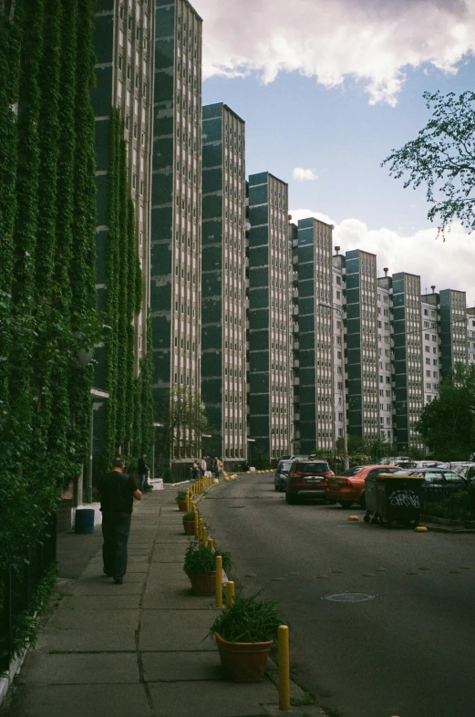 a city sidewalk next to some tall buildings