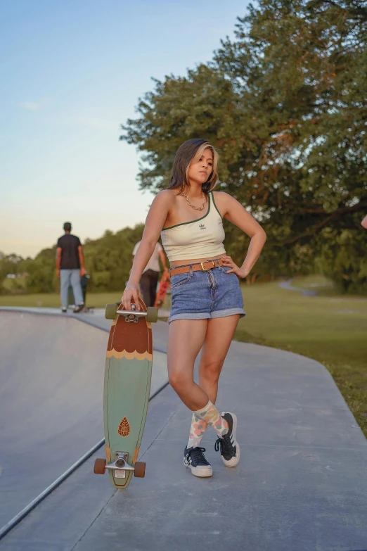 a woman with a skateboard is walking on a ramp