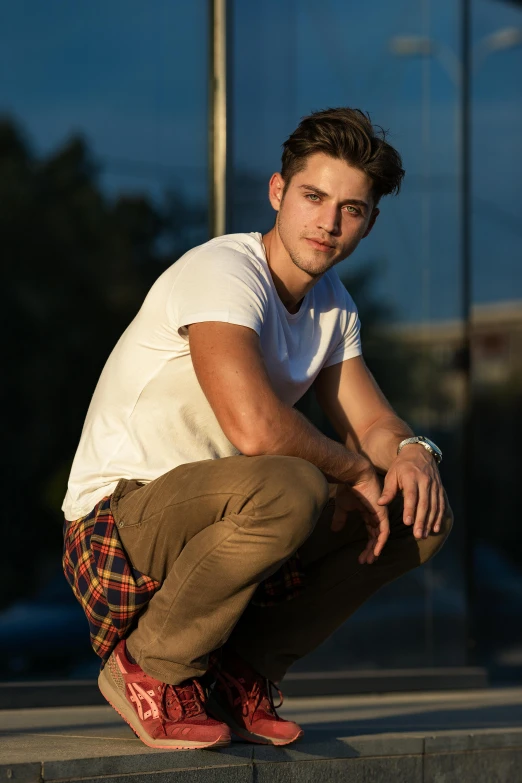 a man poses for the camera while squatting