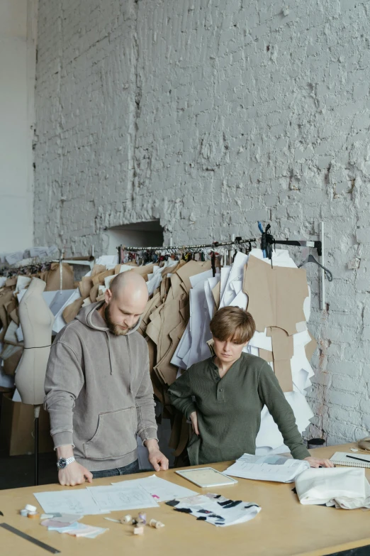 a man in a gray hoodie  a piece of cardboard