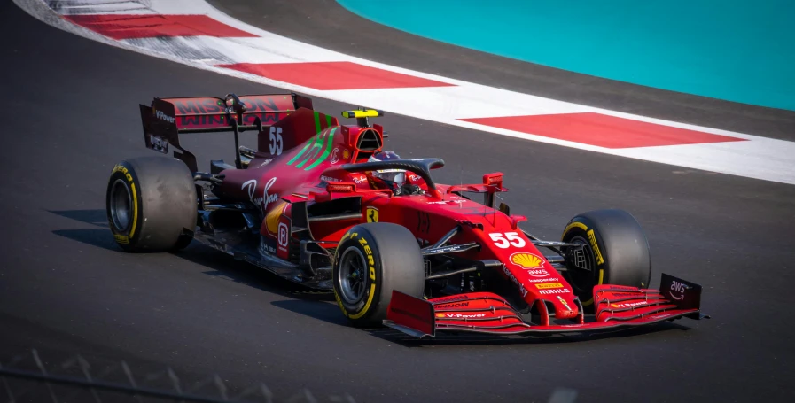 the ferrari team drives down a track during a race