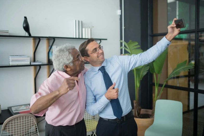 two older men pose for a selfie with an elderly woman