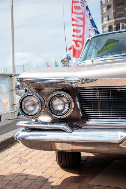 an old car with chrome grilles in a parking lot