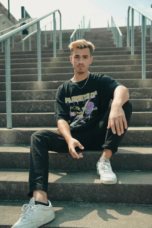 a man sitting on steps wearing sneakers