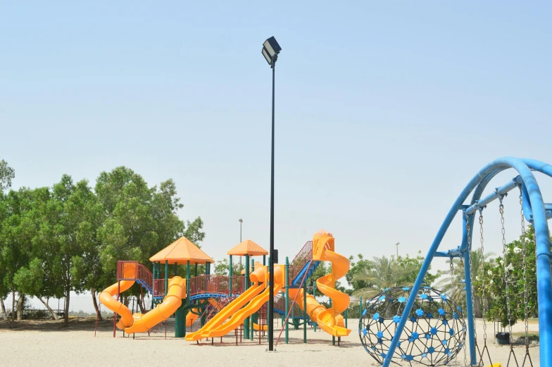 the children's play ground and playground area is set up in a sandy area