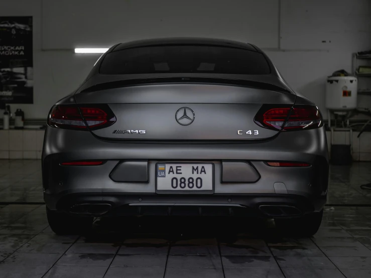 the rear view of a mercedes cla in an industrial area