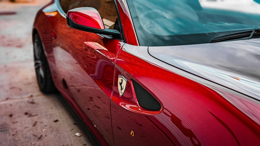 there is a side view mirror that has a ferrari logo