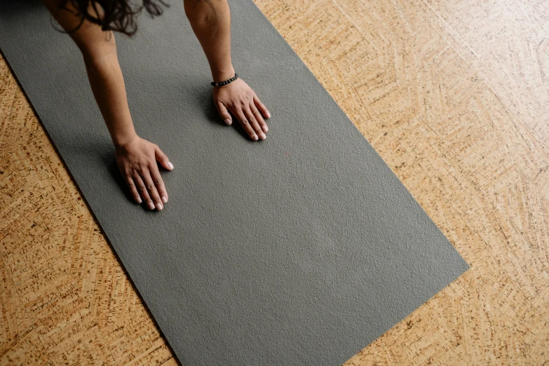 a person on a yoga mat in the middle of the floor