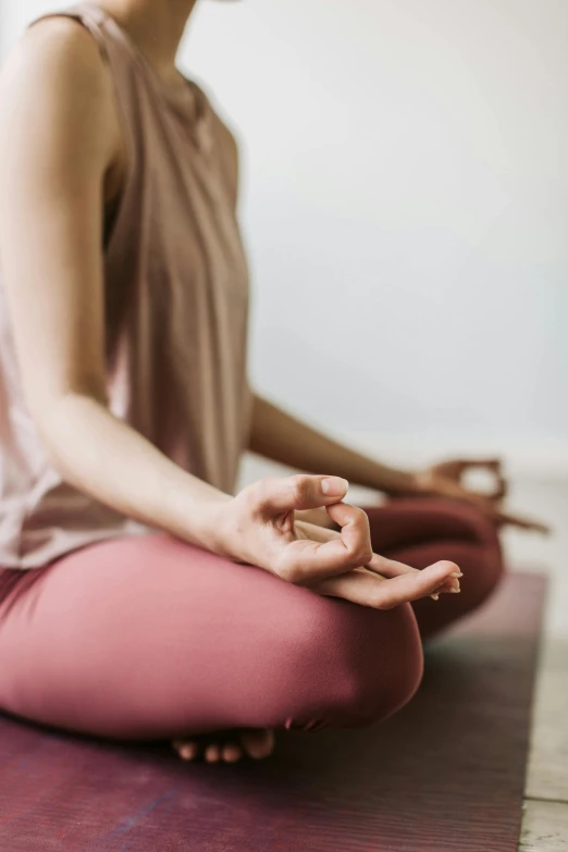 a woman practices the asasana exercise on her yoga mat