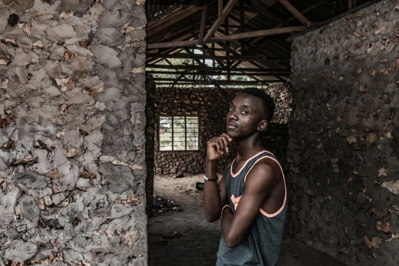 a man standing in a room with stone walls