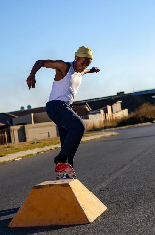 man on skateboard doing a trick in the street