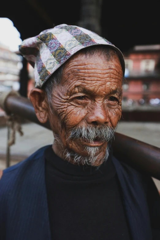 an old man with a wooden stick in his hands