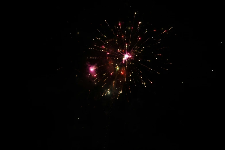 a dark sky with a firework in the middle