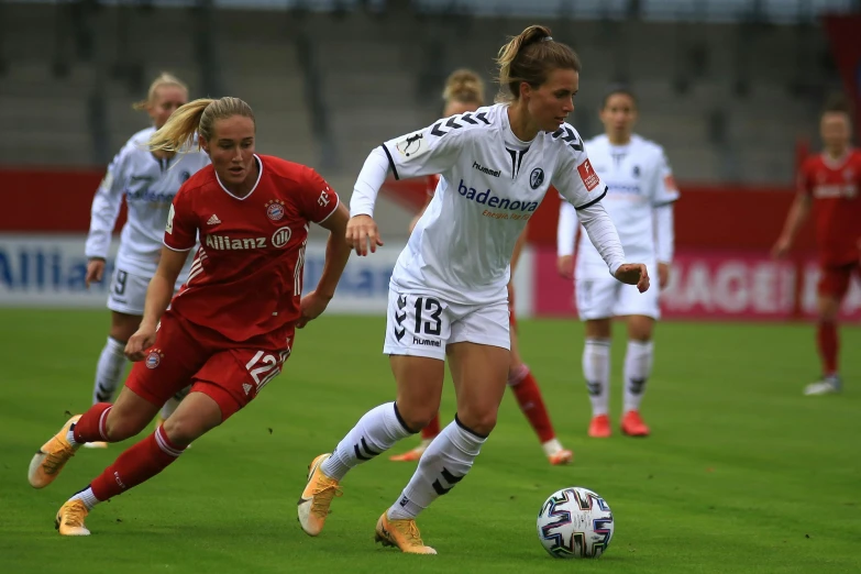 the girls are playing a game of soccer