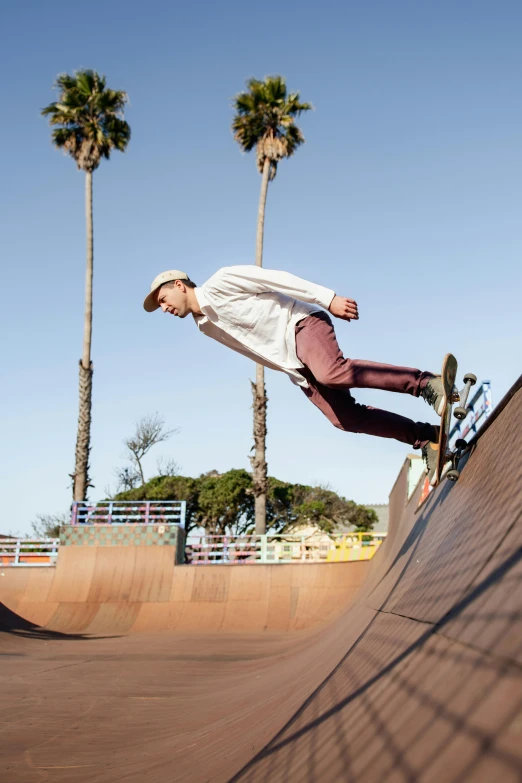 a young man is in mid air on a skateboard