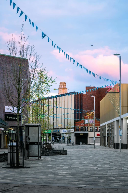 a city courtyard and walkway with building in the background