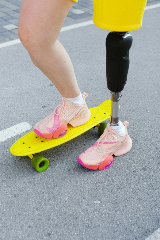 a woman wearing pink and yellow shoes riding on a skateboard