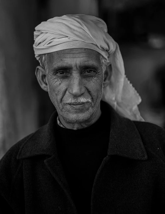 a black and white image of a man with turban