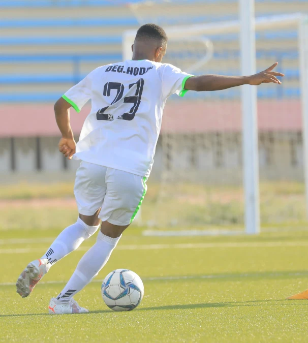 a man is playing soccer on the grass