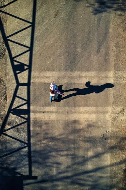 two people in white shirts walking along a dirt ground