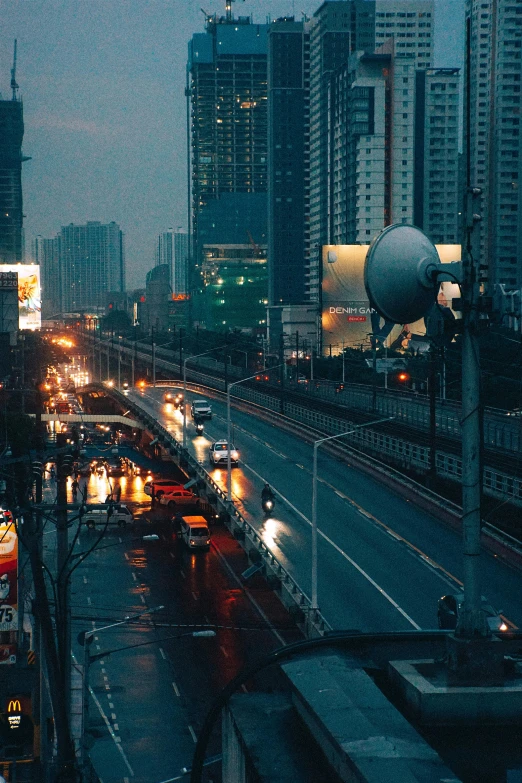 traffic on the roadway with large skyscrs in the background