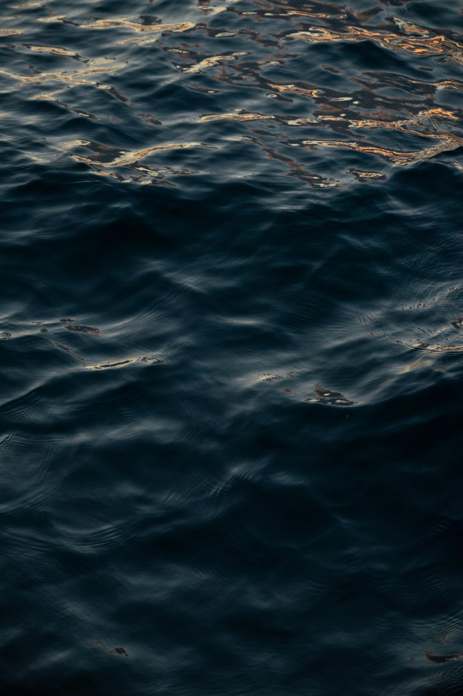 a boat floats in the ocean during the day