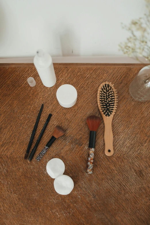 a wooden table topped with brush and brushes