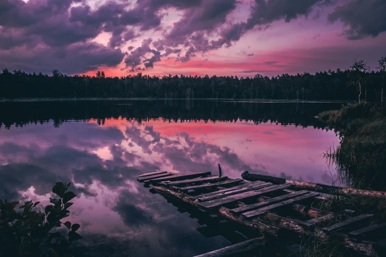 purple and red sky reflecting in the water at dusk