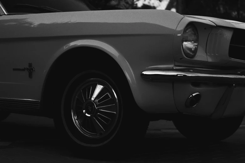 black and white po of ford mustang parked on the street