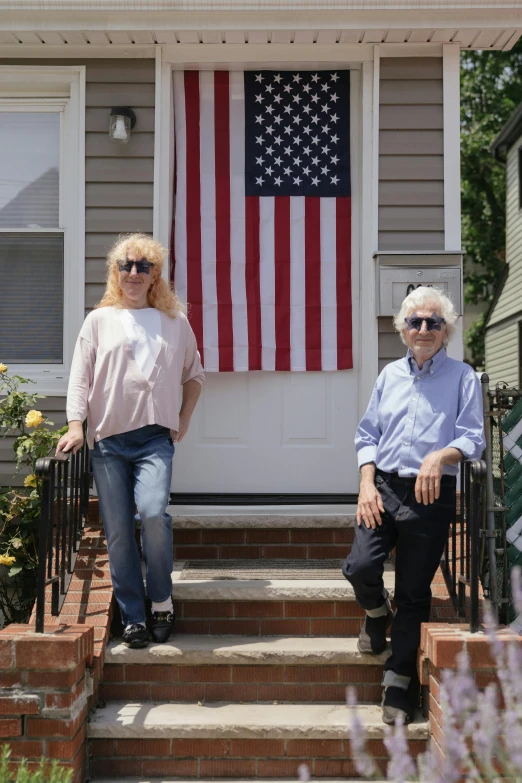 two women standing in front of the door of a house