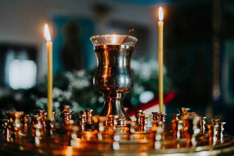 a large, silver chalice stands with several smaller ones on it