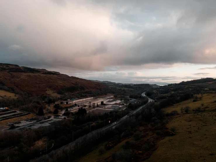 the cloudy sky over a valley and land