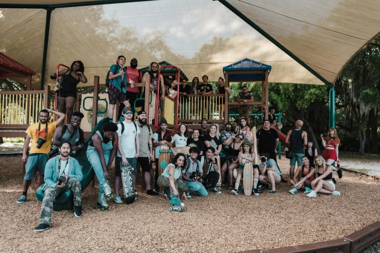 a group of people are posing for a picture outside in a tent