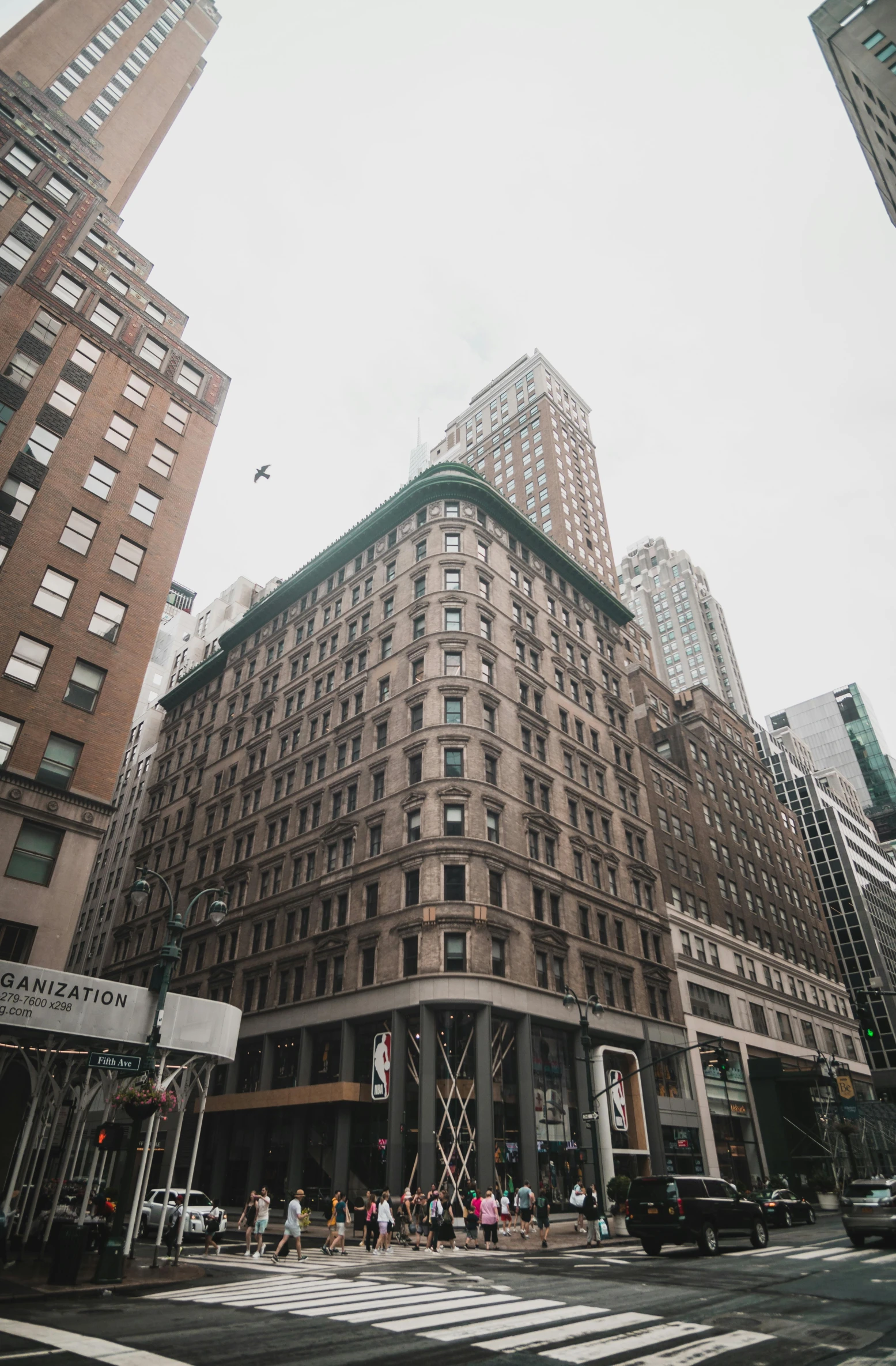 the corner of an intersection with tall buildings