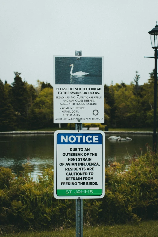 a sign that warns not to swim near the lake