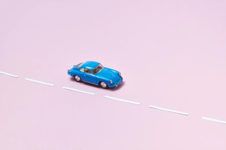 a blue toy car that is on a line