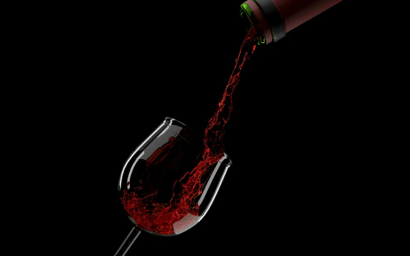 red wine is being poured into a wine glass