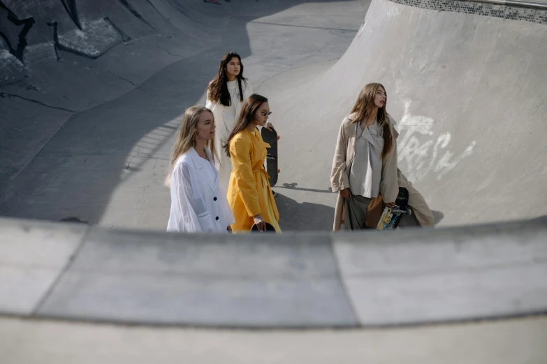 some girls are standing on a skateboard ramp