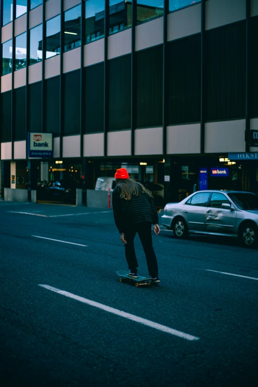 a man on his skateboard on the side of the road