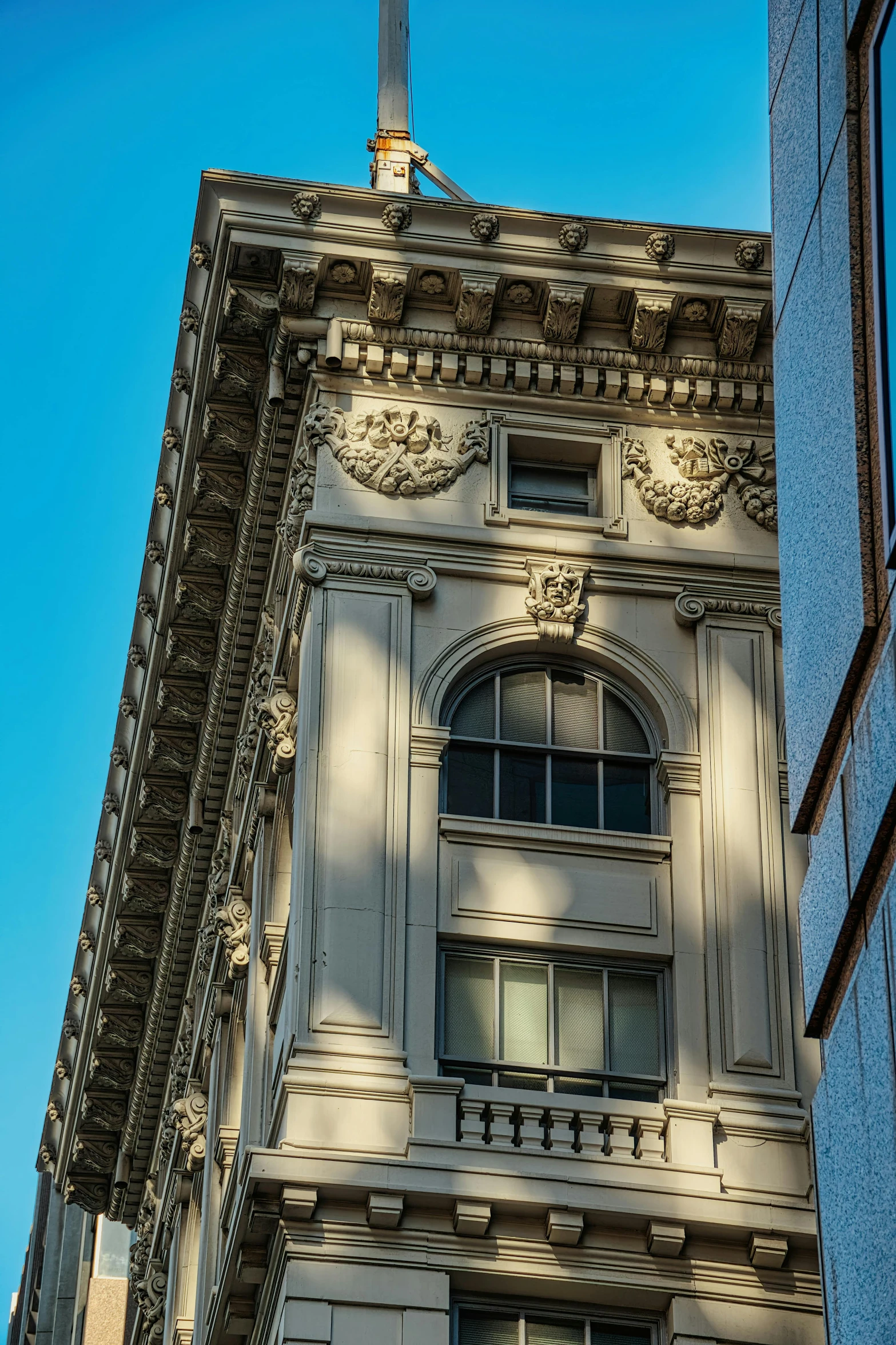 the building is gray and white with a cross on top