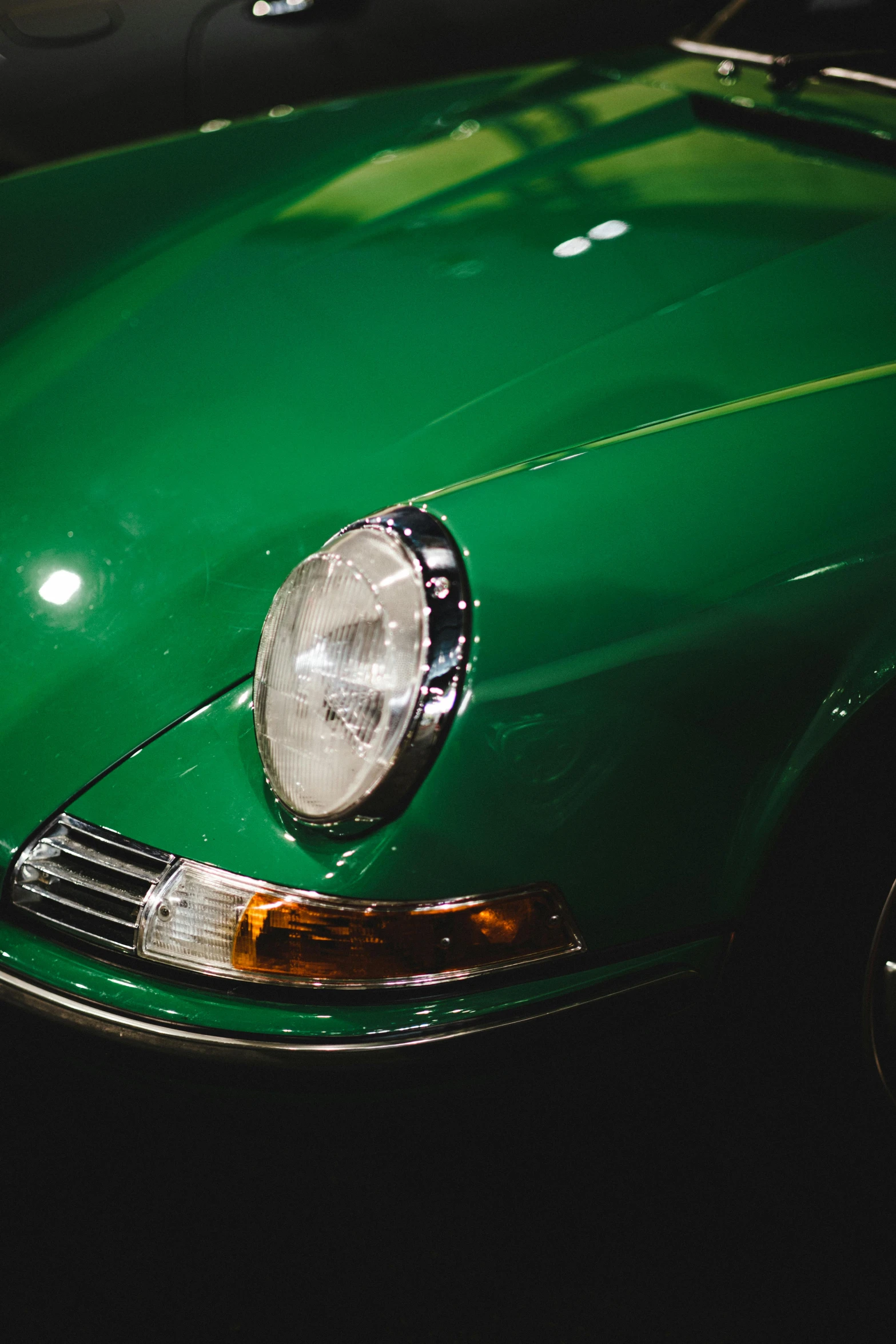 the front end of a green car with its hood up