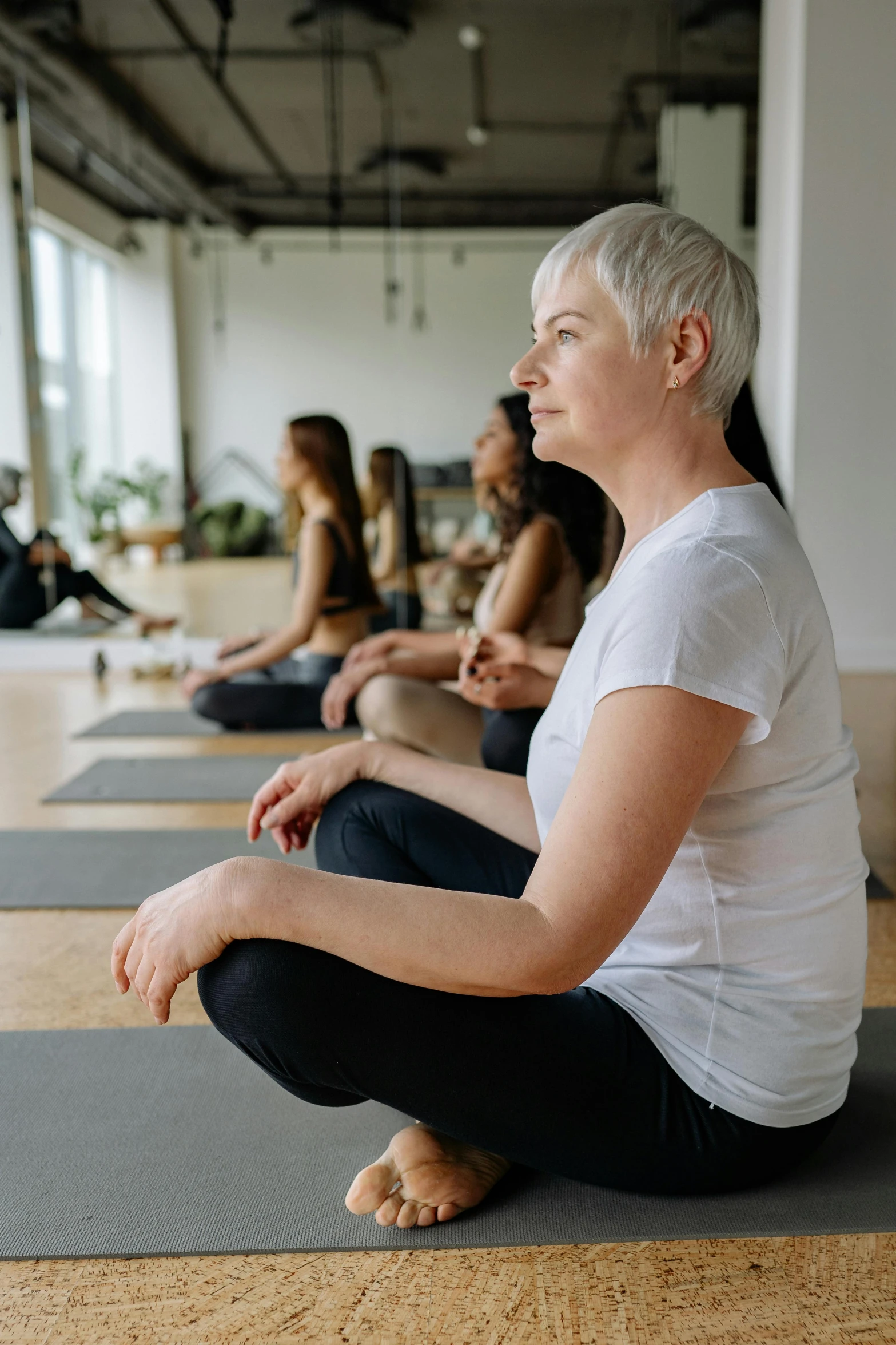 some women are doing yoga at a group