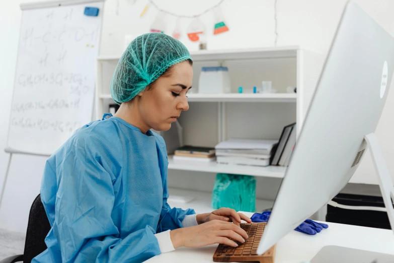 a woman working on a laptop computer in a lab