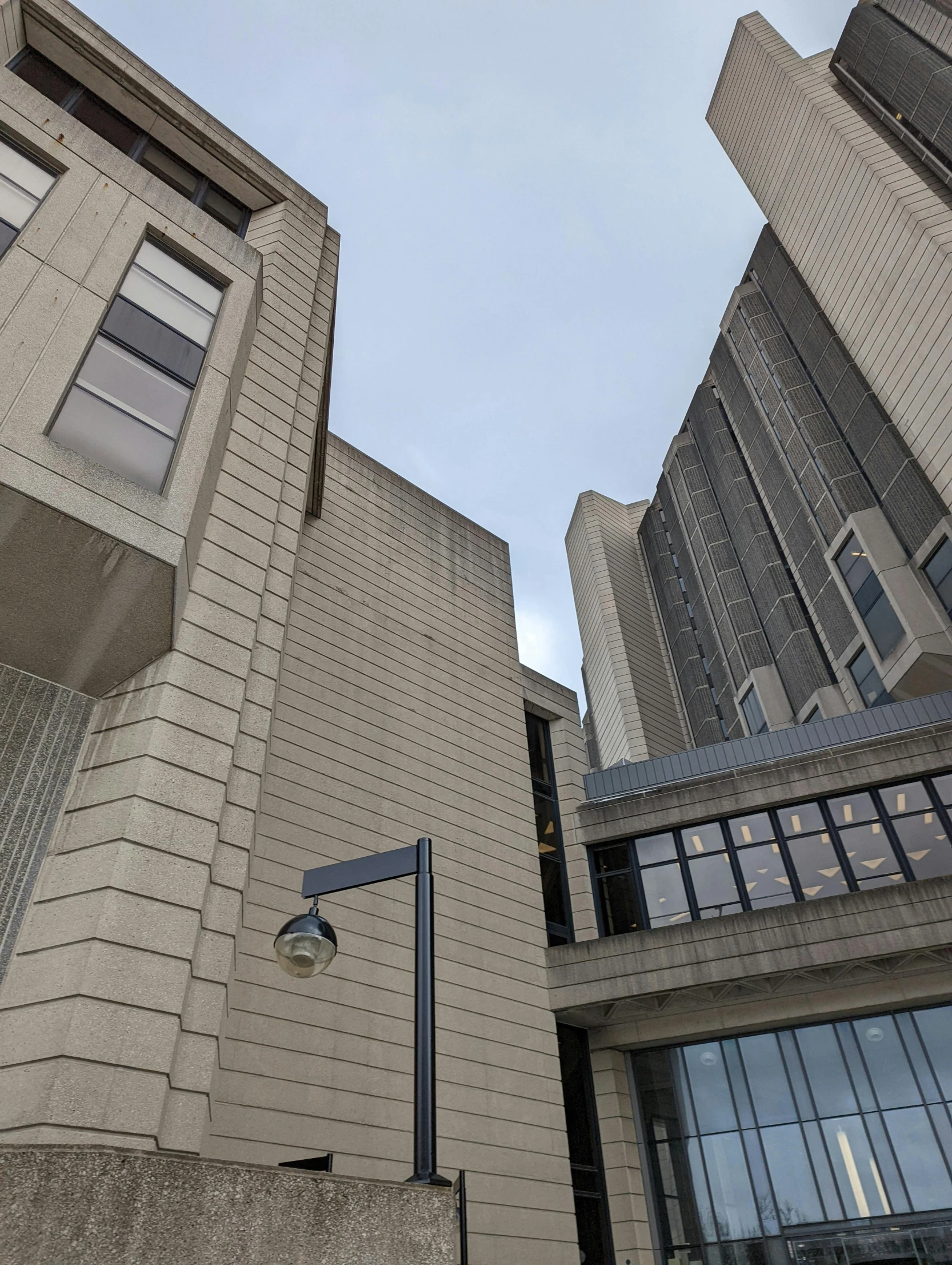 a building with three different windows next to a tall street light