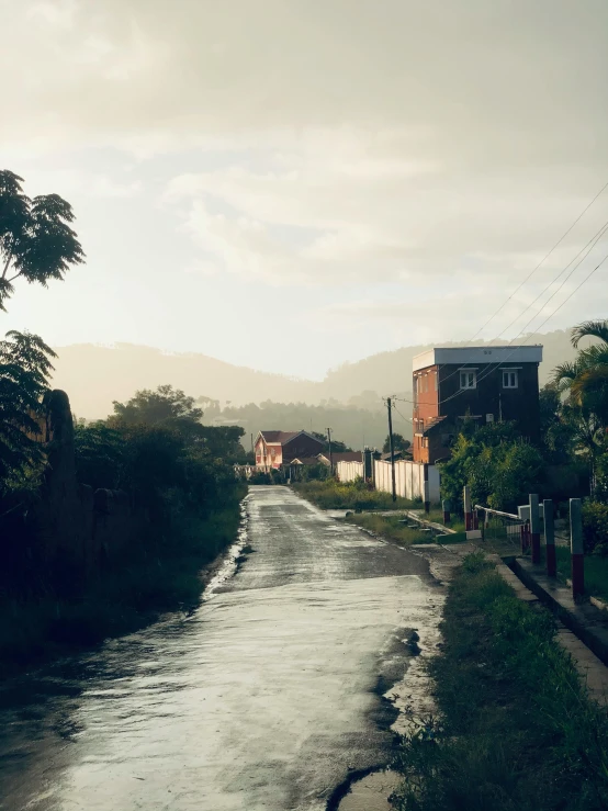 a wide, flooded street next to some buildings