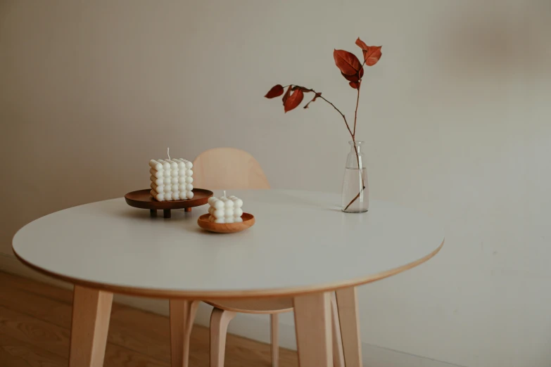 a white cake and flower on a small table