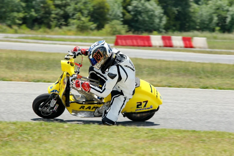 a man on a yellow and black motorcycle wearing an outfit