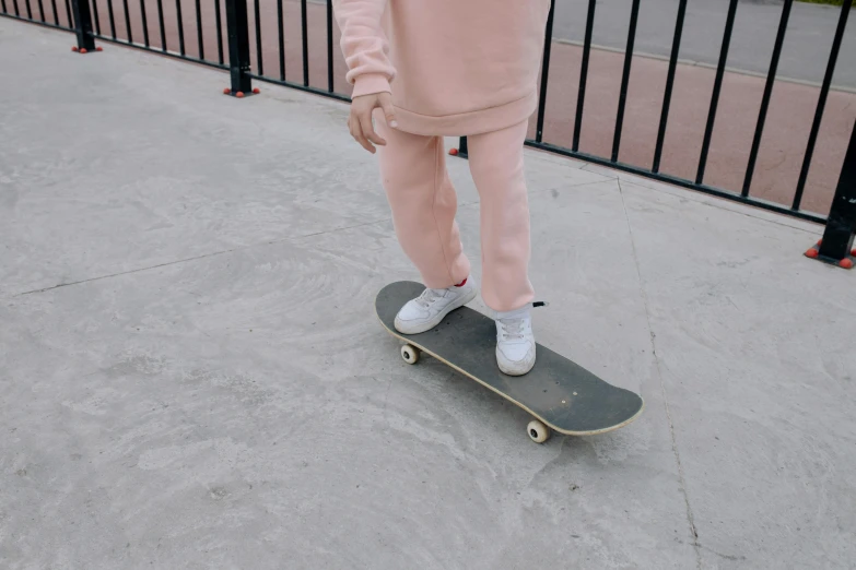 a person standing on a skateboard on the ground